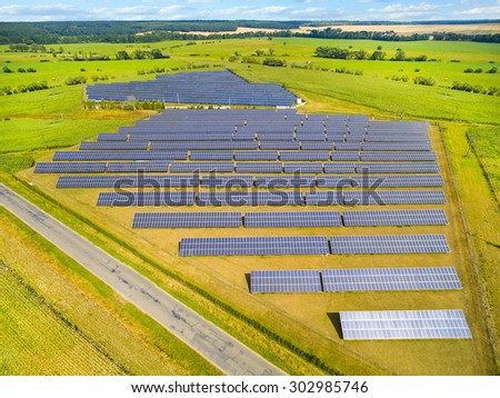 Aerial view to solar power plant. Industrial background on renewable resources theme.