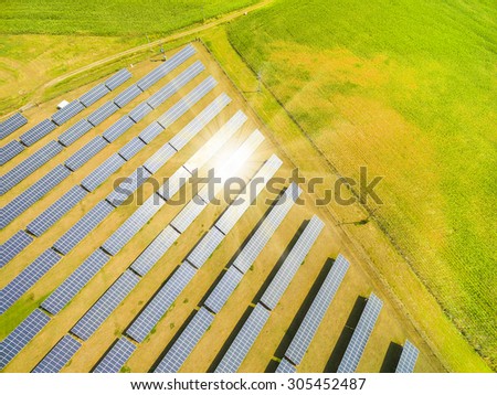 Aerial view to solar power plant. Industrial background on renewable resources theme.