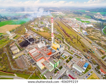 Modern combined heat and power plant from above. Fuming chimney with sulphur removal unit. Aerial view of heavy industry.