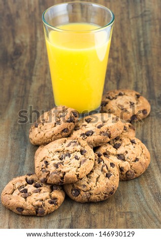 Chocolate chip cookies and glass of orange juice