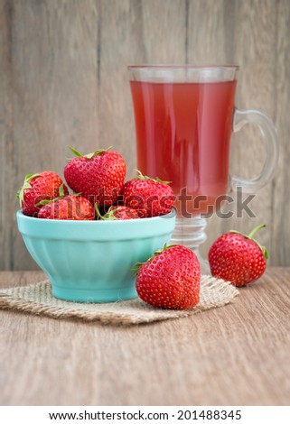 Strawberry drink with fresh strawberry fruits on an old wooden table