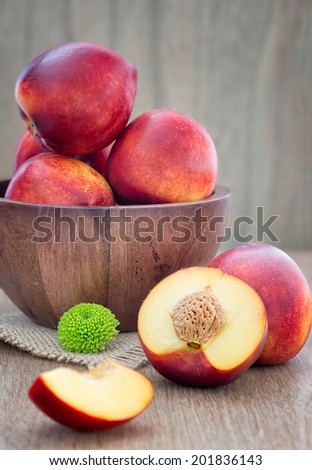 Juicy fresh peaches on  wooden background