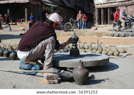 BHAKTAPUR,NEPAL - DECEMBER 29 : Man is working on wood potter\'s wheel on the Durbar square December 29, 2007 in Bhaktapur,Nepal .Bhaktapur is ancient city and one of the most popular landmarks in Asia