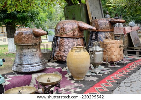 Russian samovar and old copper tanks for making traditional strong georgian alcohol drink - grape vodka, at famous Georgian flea market on the Dry Bridge Market in Tbilisi.