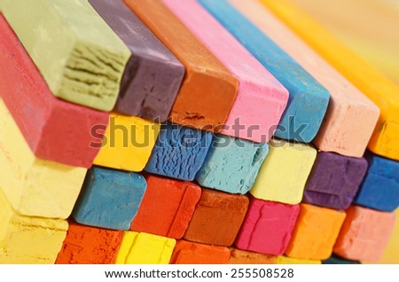 Multicolored background made of art tools - red, blue, brown,yellow, pink,orange pastel chalks