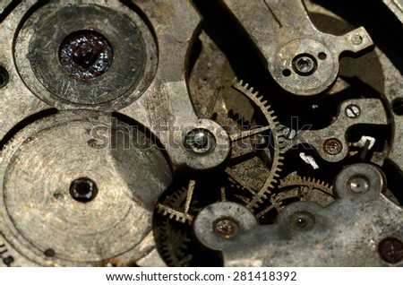 Closeup of cogweels in clockwork, grunge background for steampunk engineering design