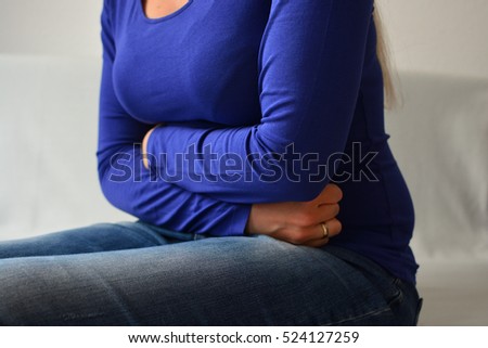 Close-up Of Woman Suffering From Stomach Ache