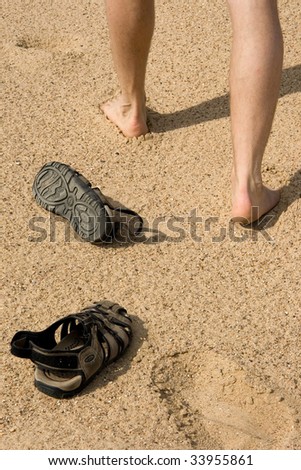 Walking man and footprints in dunes