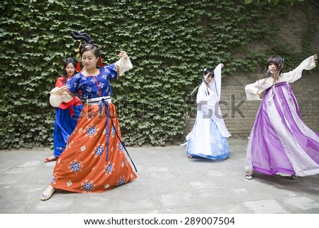 On June 20, 2015, people wear hanfu small wild goose pagoda in xi \'an, xi \'an museum dancing, teach Chinese culture to the tourists and play games.