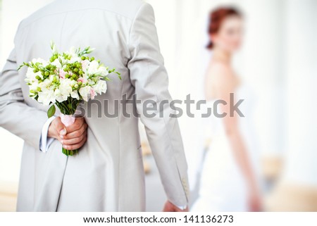 Beautiful spring wedding bouquet in hands of the groom