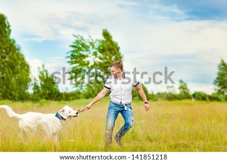 The man trains the dog. Educating dog. Play with a pet. Dog handler