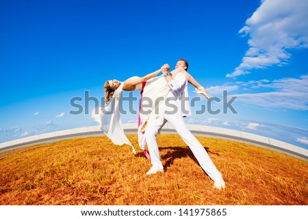 Bride and groom dancing the tango in nature. Wedding dance in the open air. Dancers love flying.