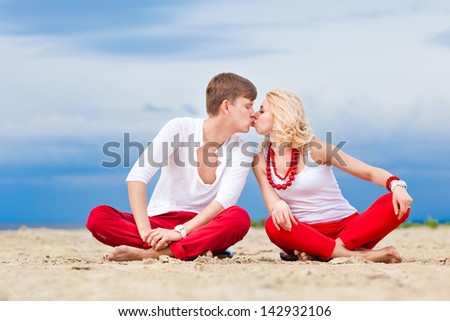 Couple on the Beach Practicing Yoga. Relaxation, meditation, healthy lifestyle.