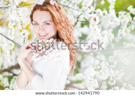 portrait of young brunette in the spring garden