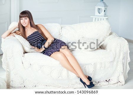 Beautiful girl sitting on the couch. Home comfort. Comfort and relaxation.