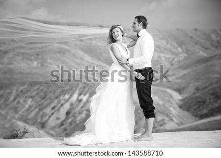 Bride and groom on the background of the desert. Summer wedding.