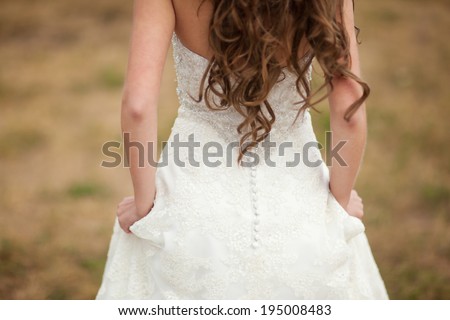 Bride turned back to the camera in nature