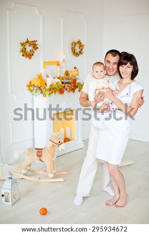 Young family with a child at home celebrating the autumn holidays. Thanksgiving Day.