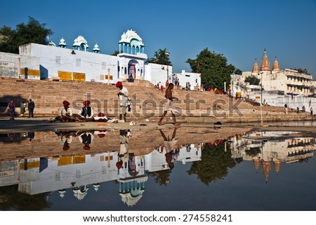 PUSHKAR, INDIA- CIRCA NOVEMBER 2013. Unidentified Hindu men prepare to Bathe early morning in Pushkar Lake, Rajasthan. A dip in the sacred lake is believed to cleanse sins and cure skin diseases