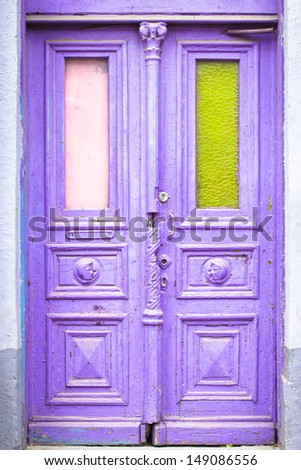 Old lilac door with green glass on the right side