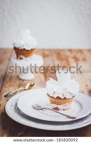 Beautiful cupcakes for wedding or little ballerina. Decorated with white sugar paste dresses. Selective focus