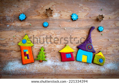 Sweet village. Colorful gingerbread cookies on wooden background