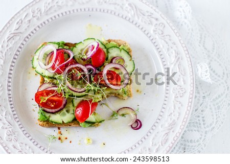 Vegan sandwich missing one bite, top view