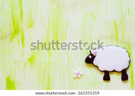 Little sheep cookie on panted background. Selective focus.