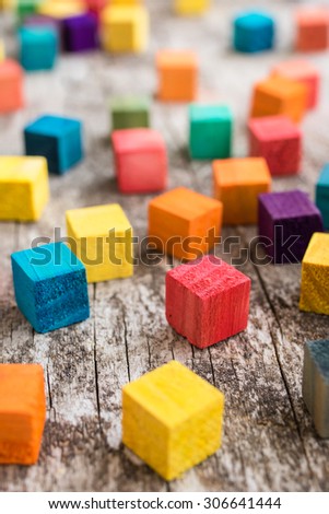 Colorful wooden building blocks. Selective focus on red block.