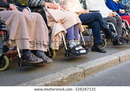 Row of old people in wheel chairs. Selective focus