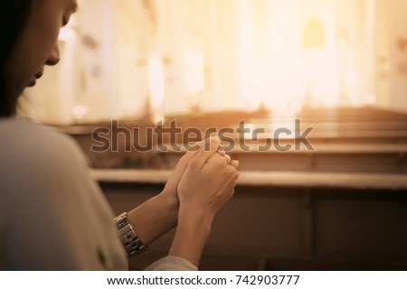 Woman in the church and prays to God , Woman with clasped hands in the church. Concept for Faith, Spirituality and Religion. Vintage tone effect.