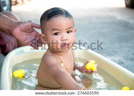 Asian baby having bath