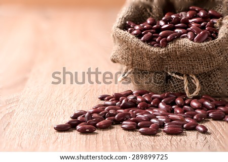 Kidney bean,Red beans in sack on wood table