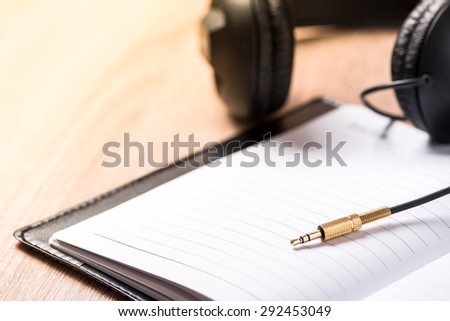 book and headphone on wood table ,music idea