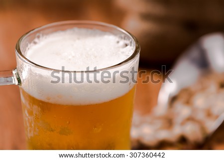 closeup beer in mug glass on wood table