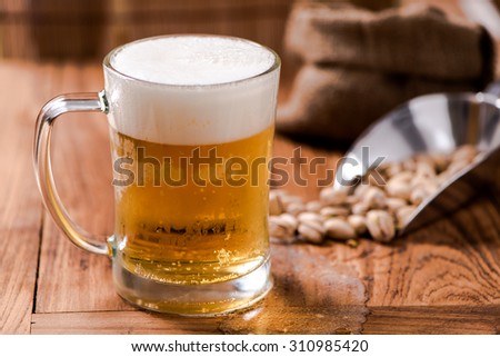 beer in mug glass with bean on wood table