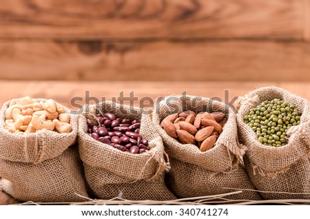 background of Almond and green bean and kidney bean and cashew nut in sack on wood table