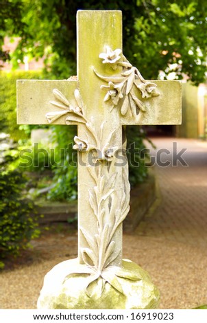 Stone cross with floral motive on a graveyard in Southern England