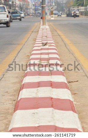 red and white concrete barrier on road