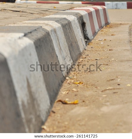 black and white concrete barrier on road