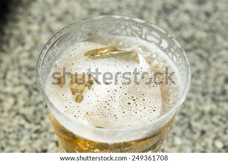 cold beer with ice in Disposable Cup