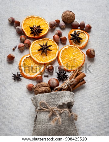 Christmas decoration with ,star anise,cinnamon stick,nuts and slices of dried oranges. top view
