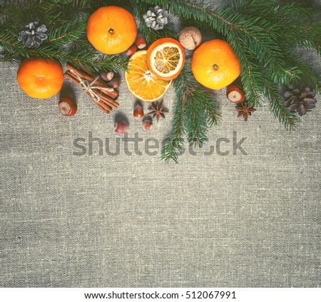 New year and Christmas card. Holiday and celebration concept.  Fir branch with Christmas spices and tangerines. Christmas background.