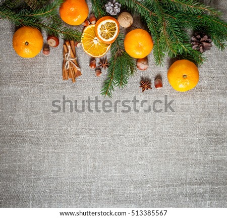 New year and Christmas card. Holiday and celebration concept.  Fir branch with Christmas spices and nuts. Christmas background.