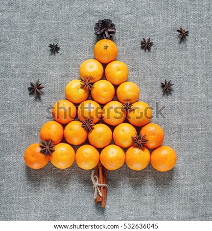 New year and Christmas card. Holiday and celebration concept. Christmas tree of tangerines with star anise. Christmas and New Year's background.