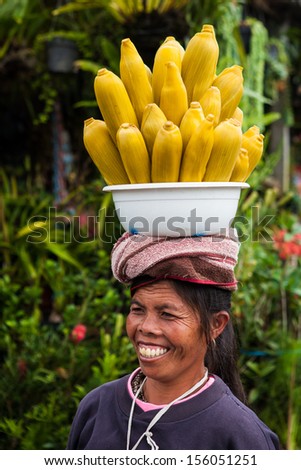 BALI - MARCH 19: Balinese woman selling corn in a maket on March 19, 2012 in Bali, Indonesia.