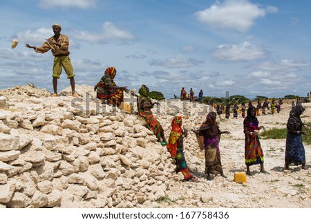 GAYO VILLAGE, ETHIOPIA - JUNE 19: Women work on building a well which is used by the people and animals as the only water source nearby on June 19, 2012 in Gayo village, Ethiopia.