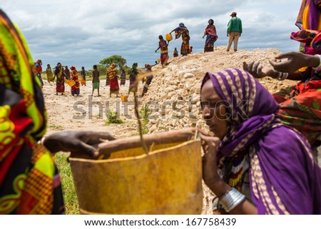 GAYO VILLAGE, ETHIOPIA - JUNE 19: Women work on building a well which is used by the people and animals as the only water source nearby on June 19, 2012 in Gayo village, Ethiopia.