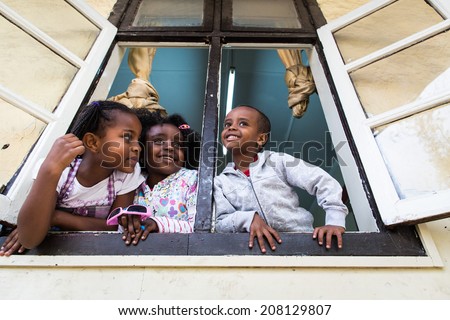 ADDIS ABABA, ETHIOPIA - JUNE 17: Young unidentified school children play in the window of a catholic school and church on June 17, 2012 in Addis Ababa, Ethiopia.