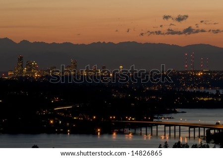 Pacific Northwest Sunset with the skyline of Seattle and the Space Needle; the Olympic Mountain Range is in the background.